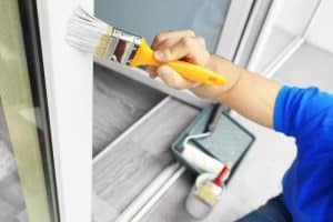 A homeowner does some repairs in a house before selling it.
