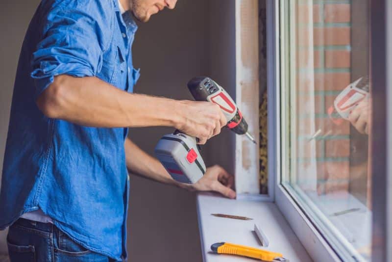 A homeowner makes some minor repairs to his house before selling it.