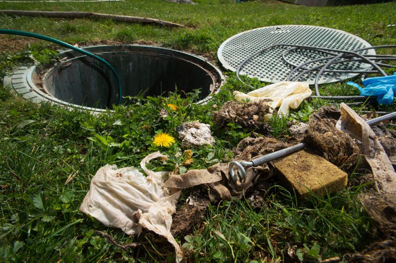 Photo of a failed septic tank with tools all around it.