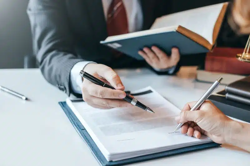 A woman consulting a lawyer about whether a trustee can be stopped from selling a property on her behalf.