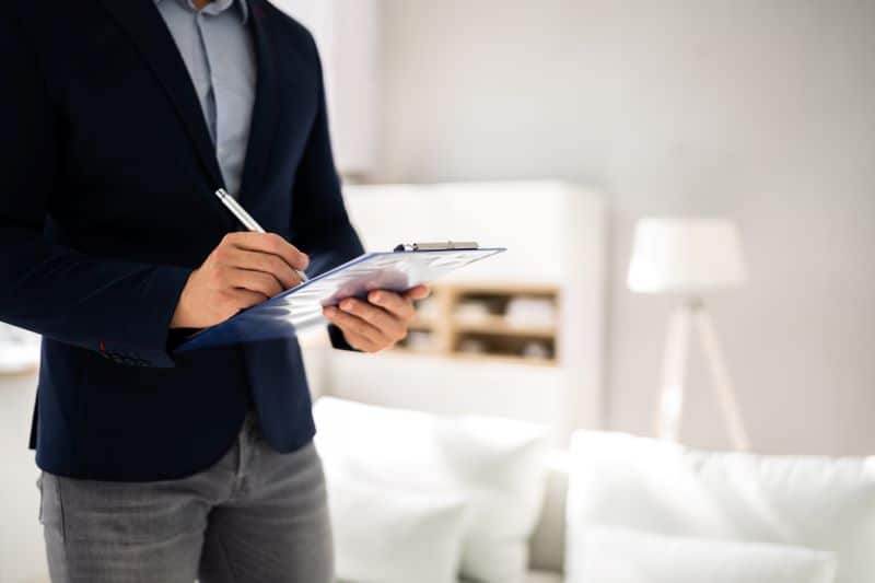 A home appraiser goes through a checklist for a house appraisal in TN.